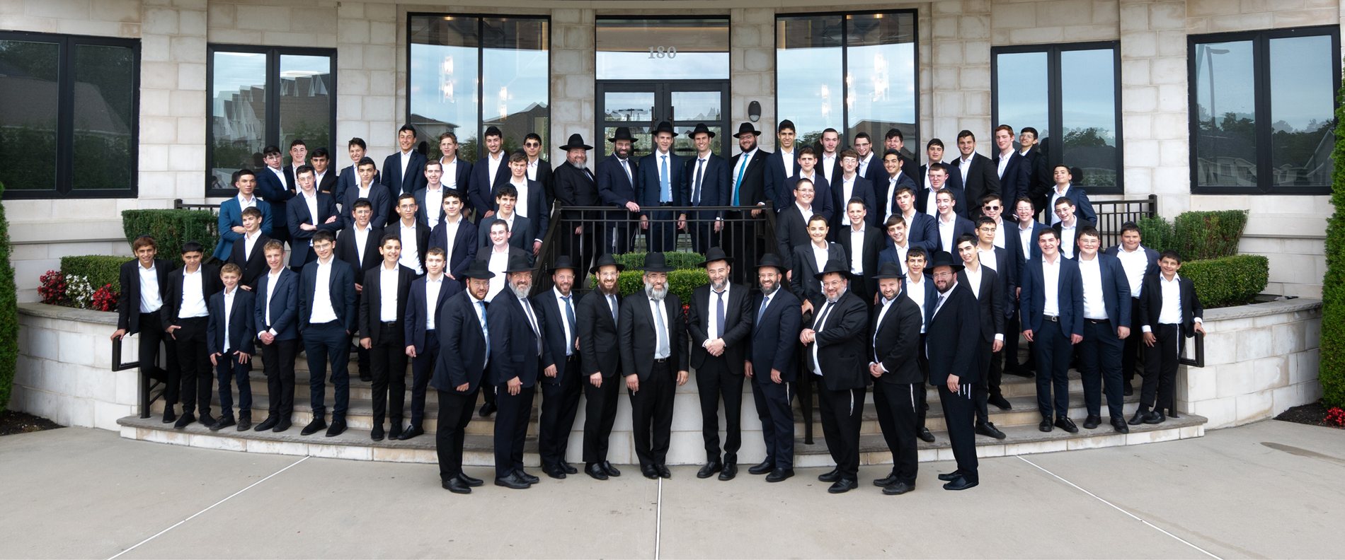The rebbeim and talmidim of Yeshiva Mekor Hatorah gathered outside the yeshiva in Lakewood, New Jersey